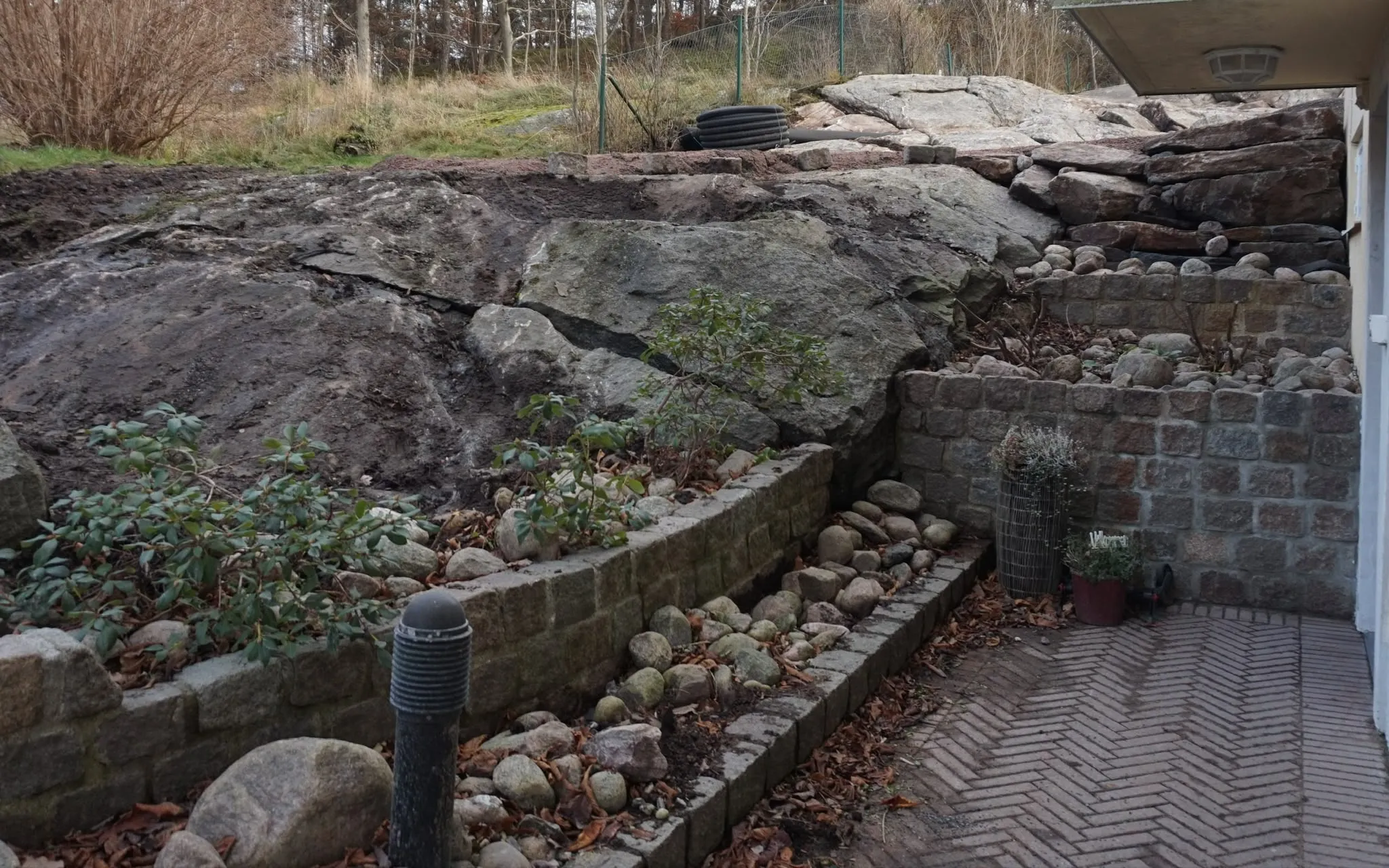 Murar och planteringar mot berget efter arbetet