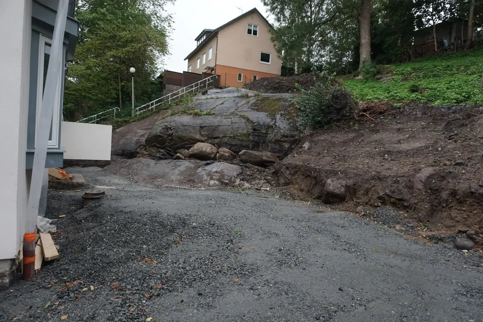 Grusyta och berg vid ett hus innan arbetet